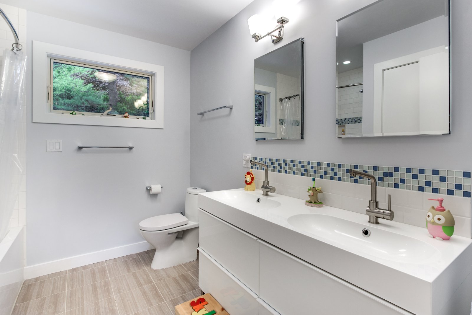 Kids bathroom remodel in Lexington, MA by Pegasus Design-to-Build with double sink vanity and colorful tile accents-optimized
