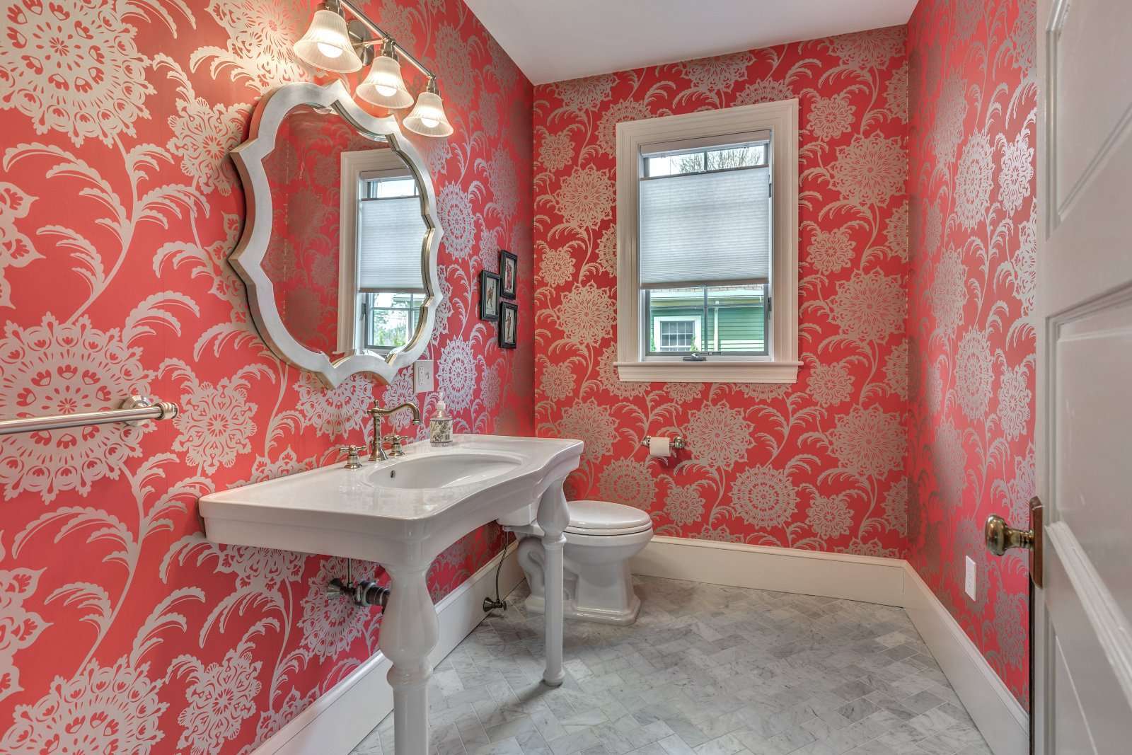 Stylish powder room in Winchester, MA by Pegasus Design-to-Build featuring patterned wallpaper and classic fixtures-optimized