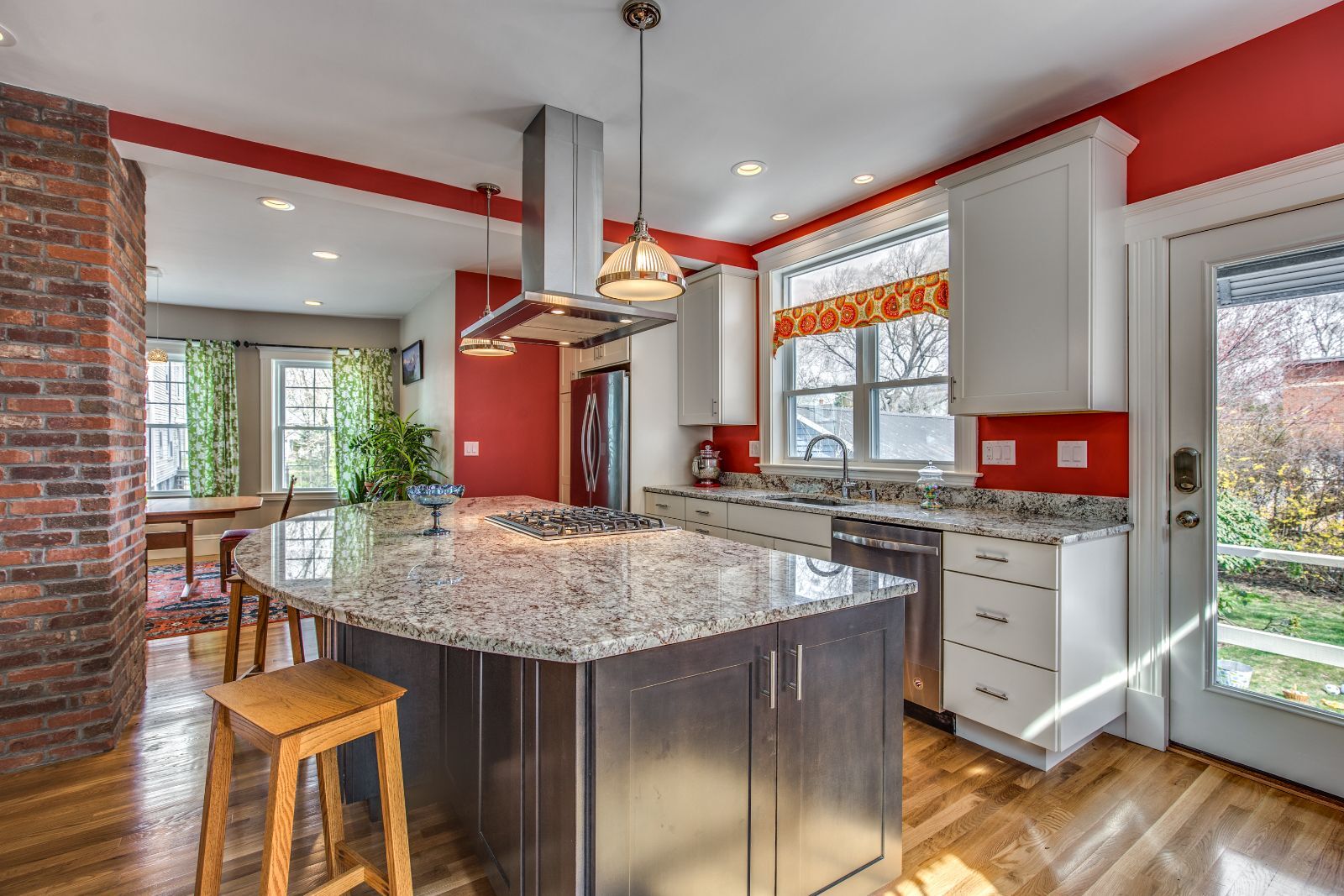 Custom kitchen remodel in Melrose, MA by Pegasus Design-to-Build featuring colorful design and island cooktop-optimized