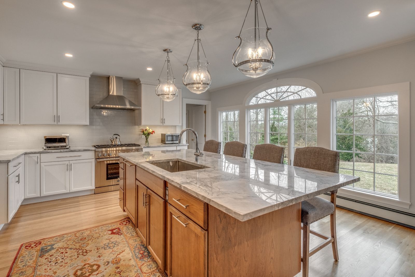 Kitchen renovation in Lexington, MA by Pegasus Design-to-Build with marble island and pendant lighting-optimized