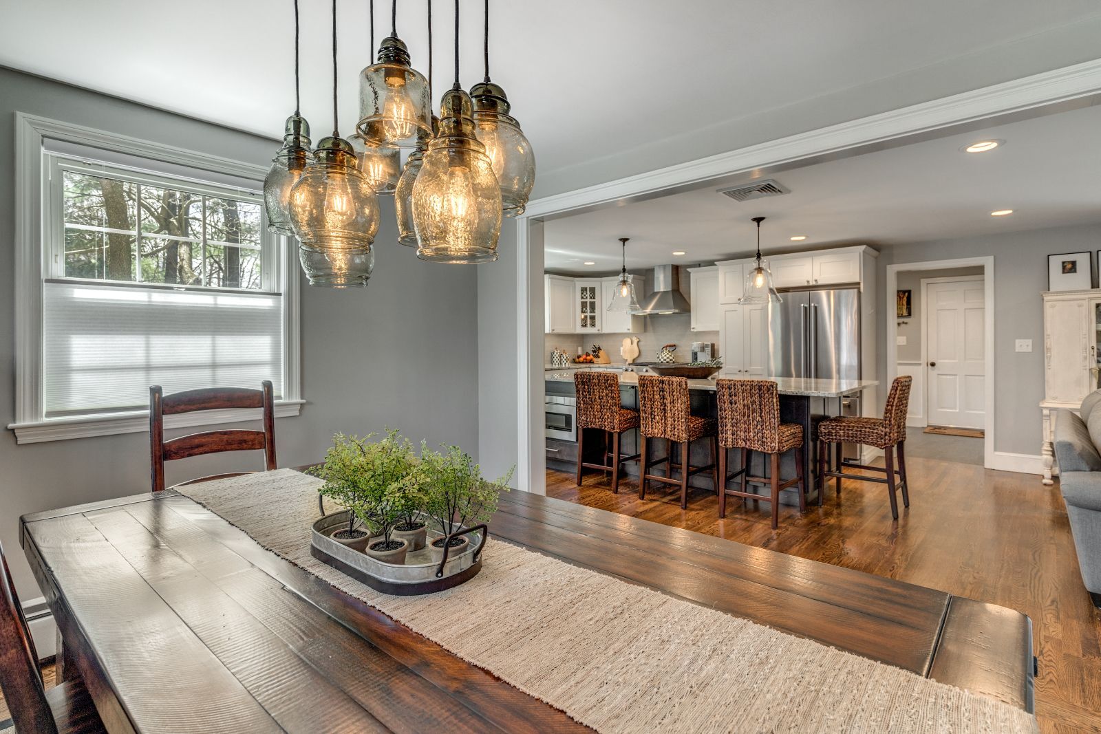 Open dining and kitchen remodel in Lexington, MA by Pegasus Design-to-Build with island seating and pendant lighting-optimized
