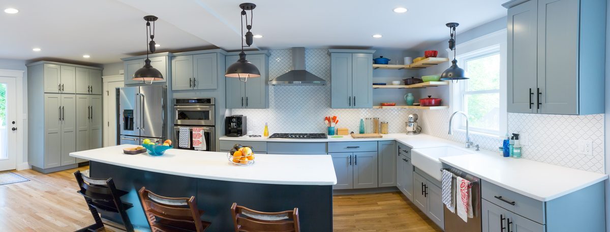 After: Sink wall: the small sink and dark wood cabinets became a farmhouse sink under a raised window, with open wood shelves and arabesque tile.
