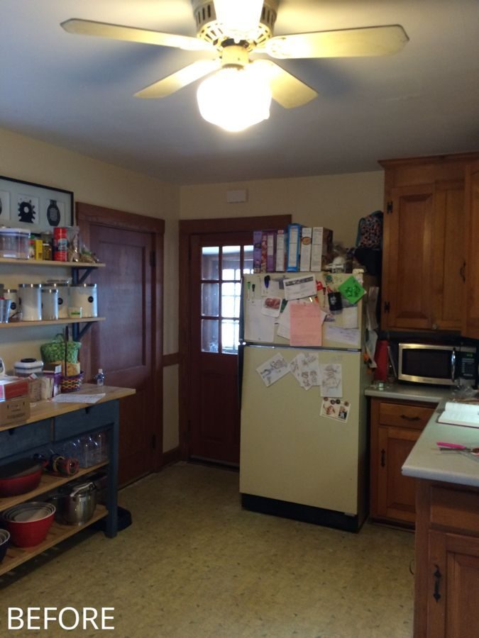 Before: Back corner: the old fridge by the back door became a wall of gray shaker cabinets, stainless fridge and double wall ovens.
