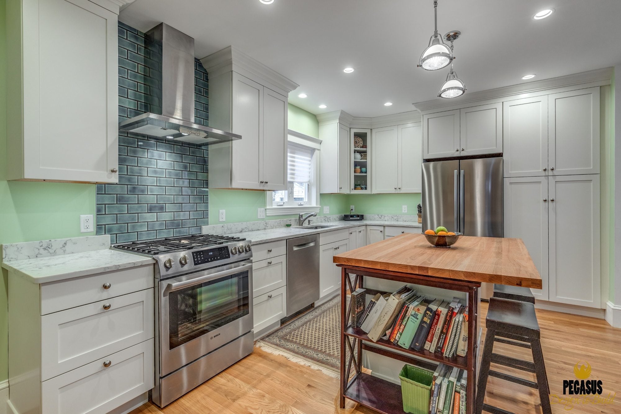 Open white kitchen with a butcher-block island in a kitchen addition in Arlington, MA