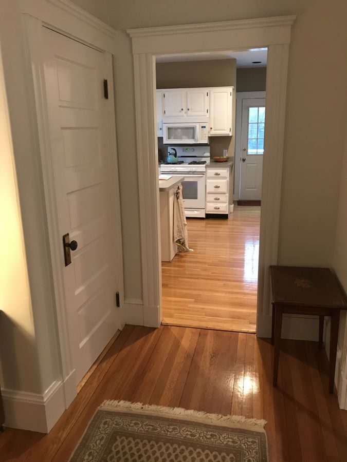 Before: Kitchen: a small galley seen through a narrow doorway became an open kitchen with a butcher-block island, a tiled range wall and a window over the sink.