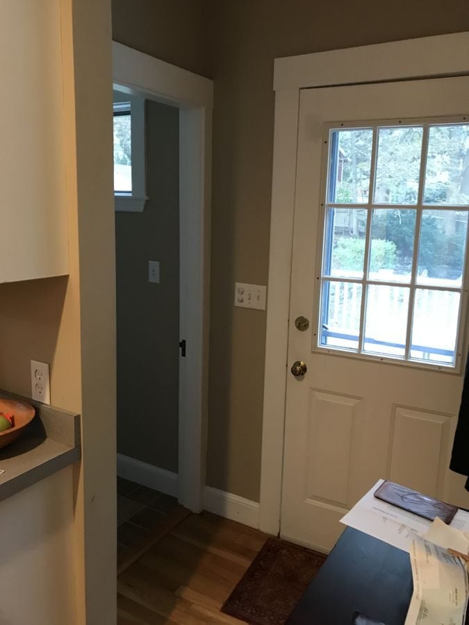 Before: Back entry: a back door squeezed beside a tiny bath became a mudroom in the new addition, with glass-front closet doors and a full bath next to it.
