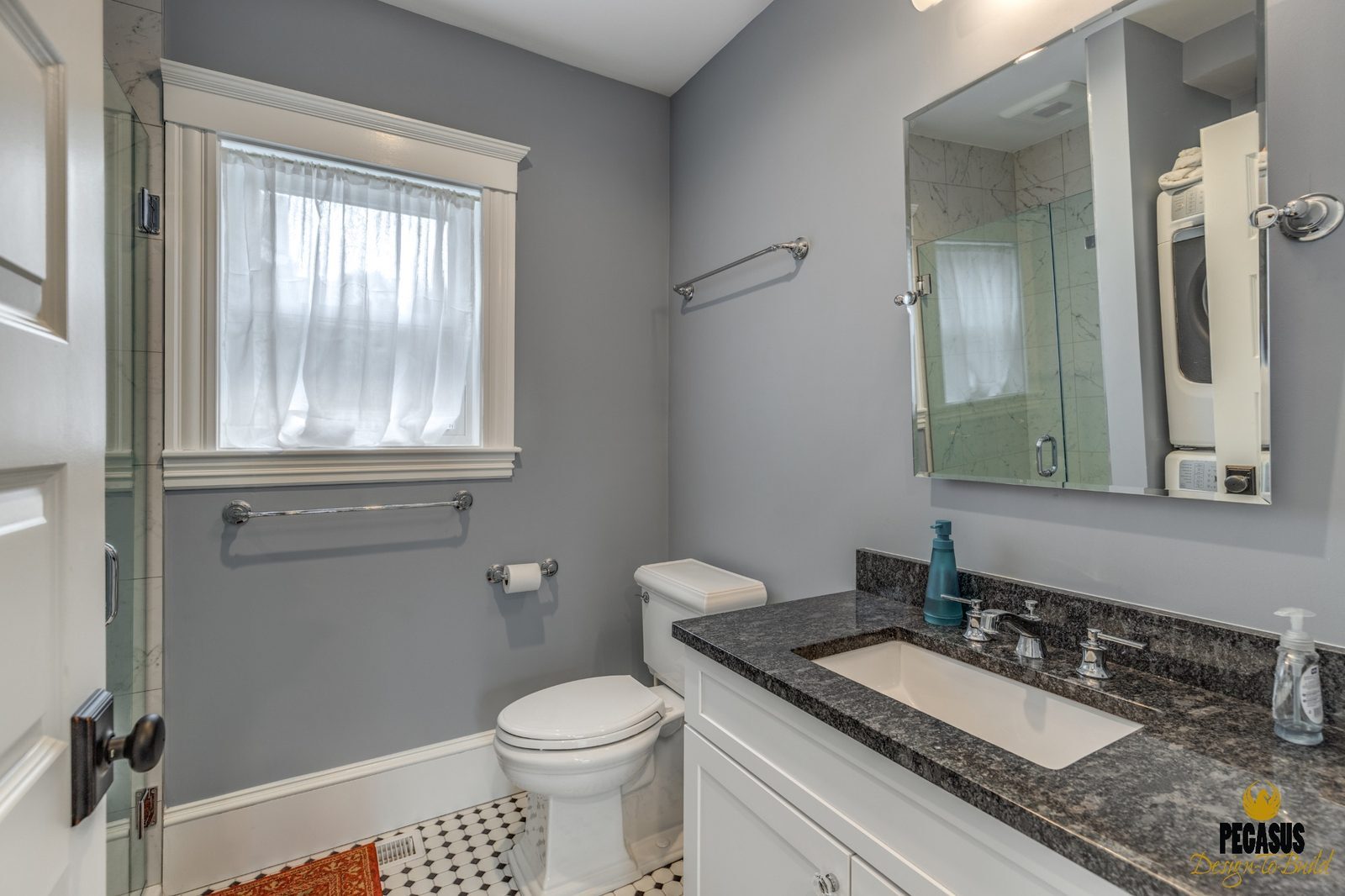 Full bath with gray walls, granite vanity and hex tile floor next to the new mudroom in Arlington, MA