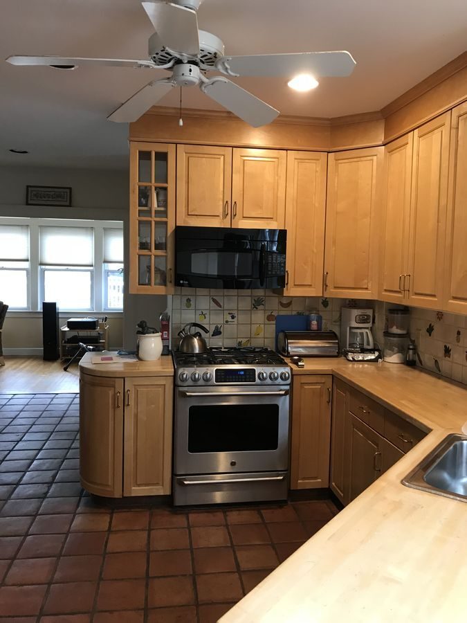 Before: Kitchen: maple cabinets, butcher-block tops and terracotta tile gave way to cherry cabinets, green granite and oak floors.