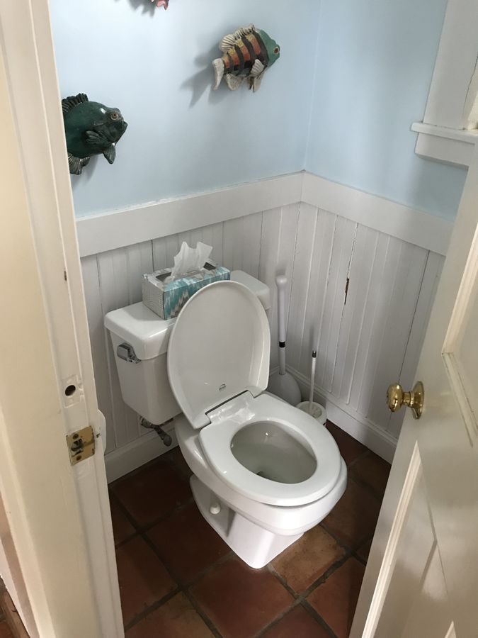 Before: Powder room: the cramped half bath off the kitchen moved into the back entry as a bright new powder room with a pedestal sink.