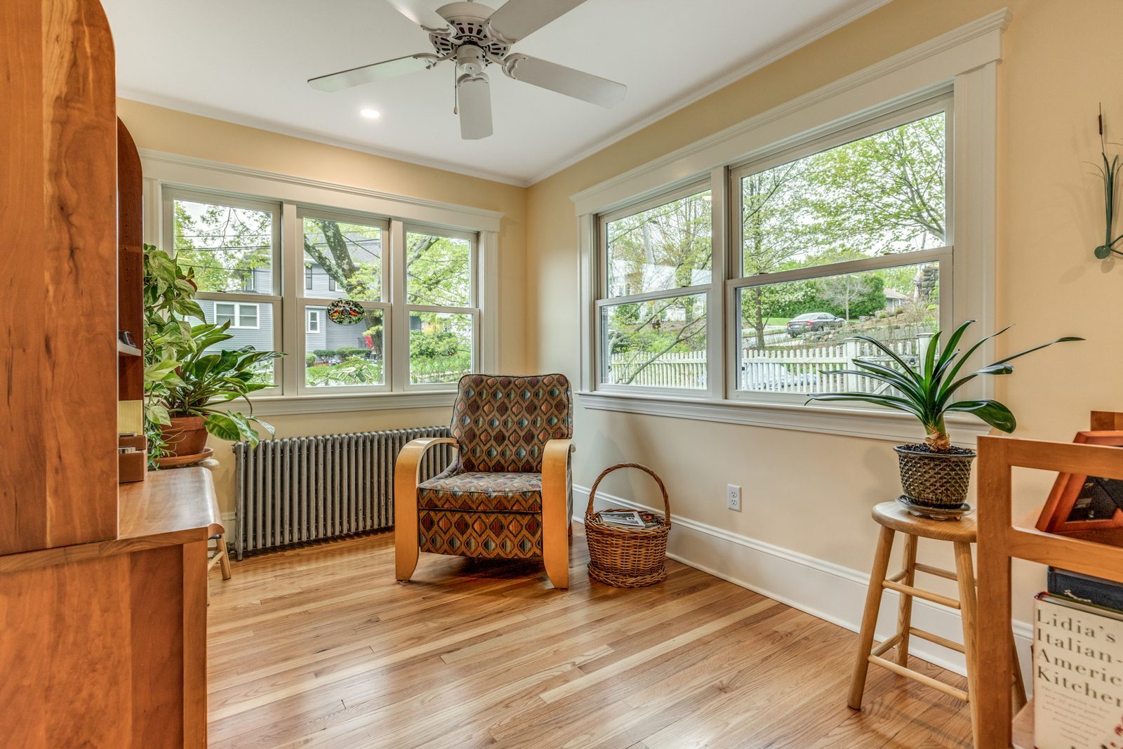 Former sunroom in Arlington, MA reframed into a family room with new windows, trim and oak floors