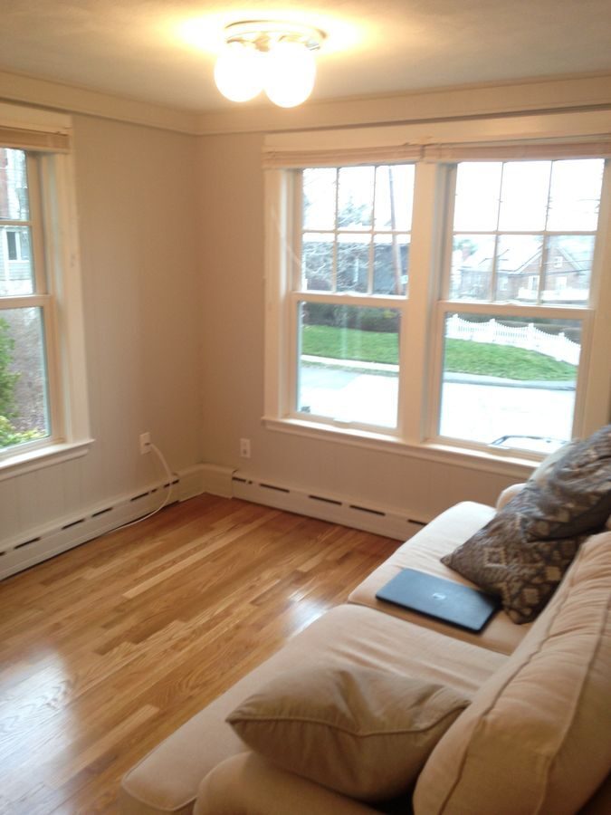 Before: Family room: the step-down sunroom got a reframed level ceiling, a gas fireplace and an open connection to the kitchen.