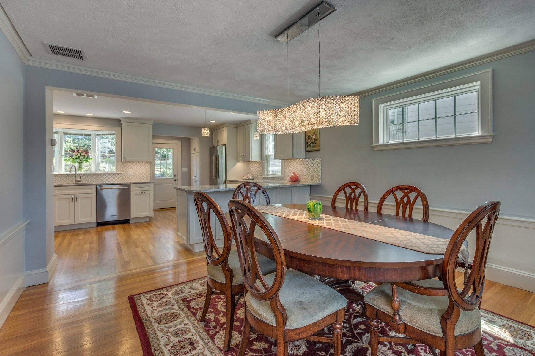 Dining room opened to the remodeled kitchen through a wide cased opening in Belmont, MA
