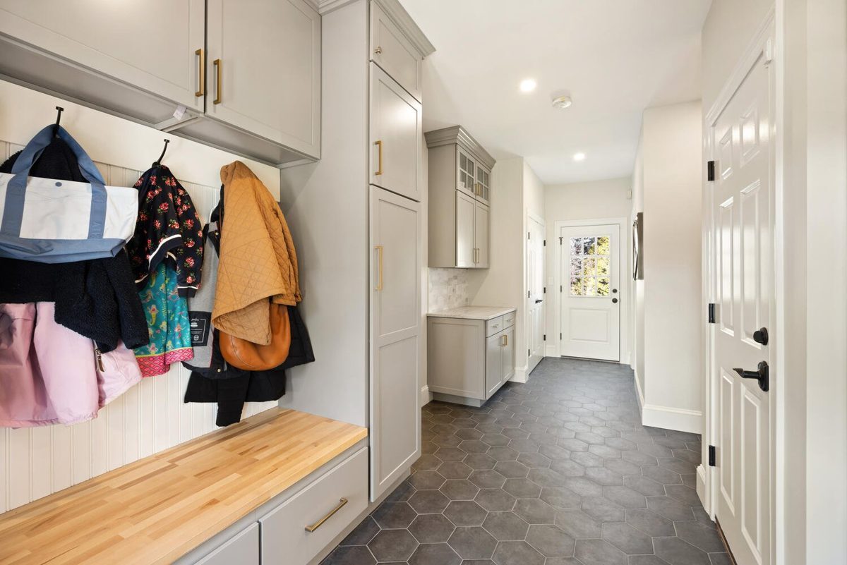 After: Mudroom: the narrow back entry became a mudroom with built-in cubbies and a butcher-block bench.