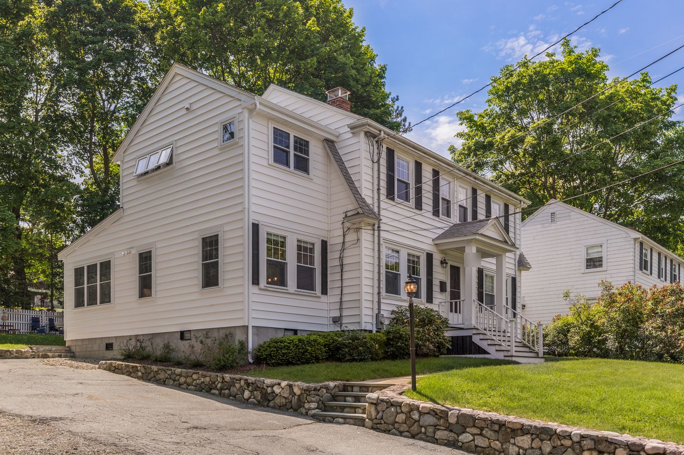 After: Outside: the one-story side wing with a rooftop railing became a full two-story addition that matches the house.