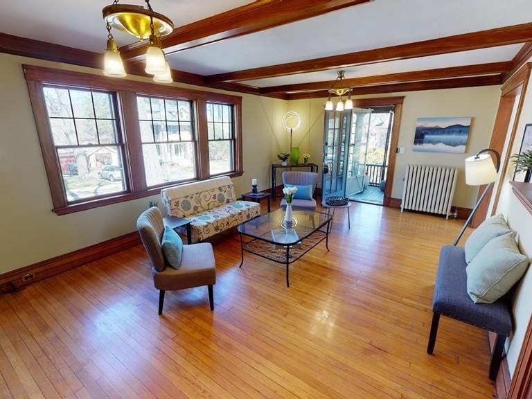 Before: Living room: the dark beamed ceiling and heavy trim are gone, and the old French door to the porch is now a sliding shoji door into the new sunroom.