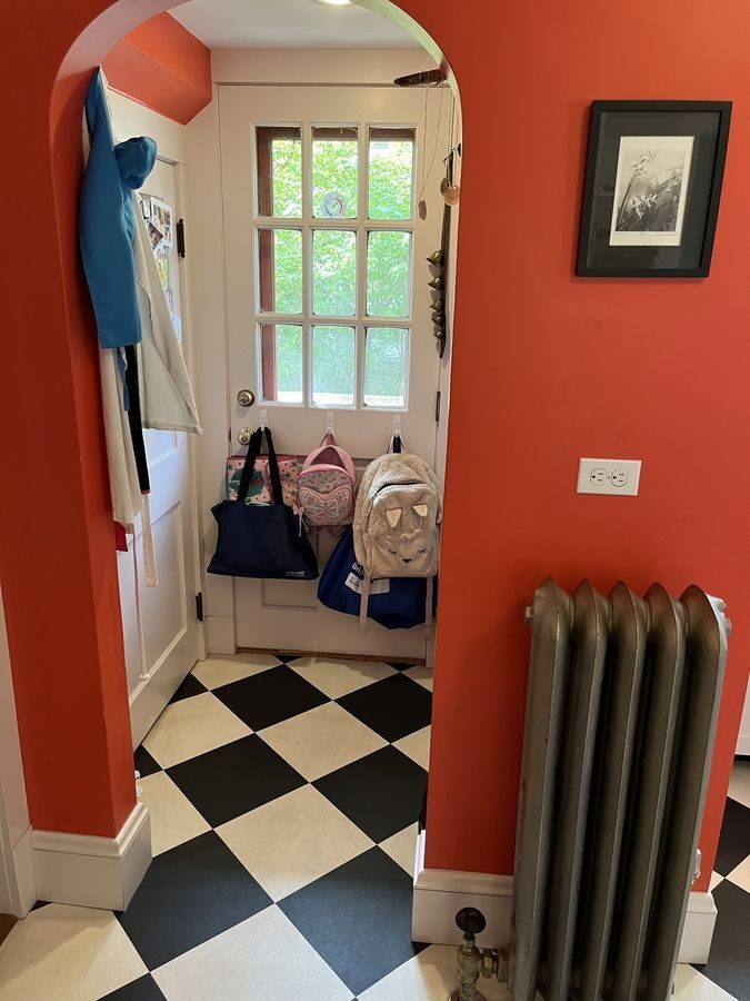 Before: Back entry: a cramped back-door nook off the kitchen gave way to a mudroom in the new addition, with a bench, hooks, beadboard and tall storage.