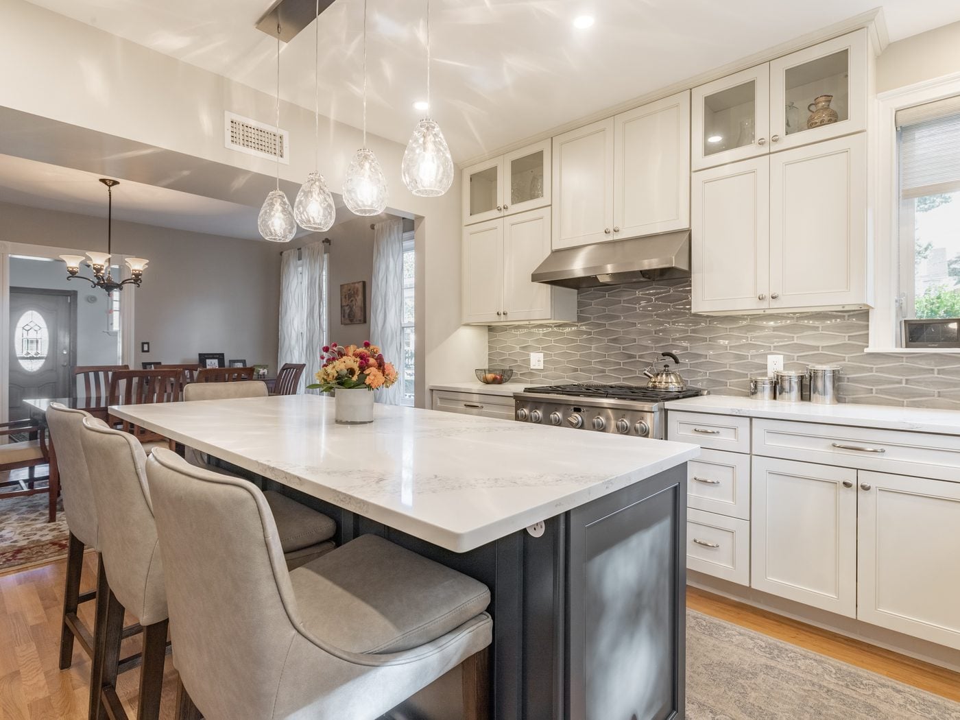After: Kitchen to dining: the built-in china cabinet and the interior chimney came out, and a wide cased opening now joins the kitchen and dining room.