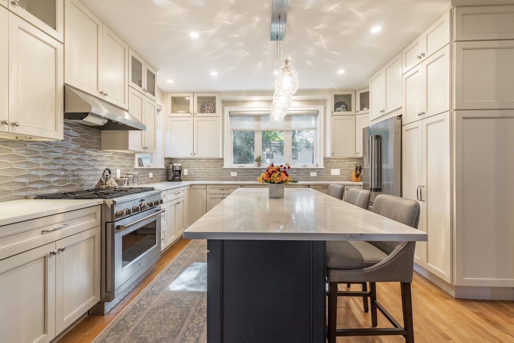 White kitchen with a navy island in a Melrose two-story addition