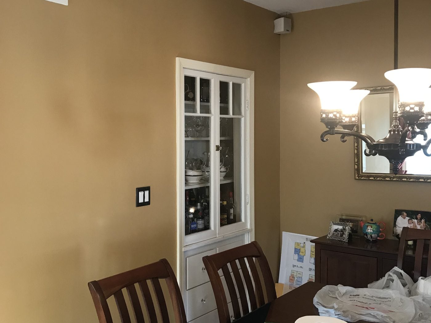 Before: Kitchen to dining: the built-in china cabinet and the interior chimney came out, and a wide cased opening now joins the kitchen and dining room.