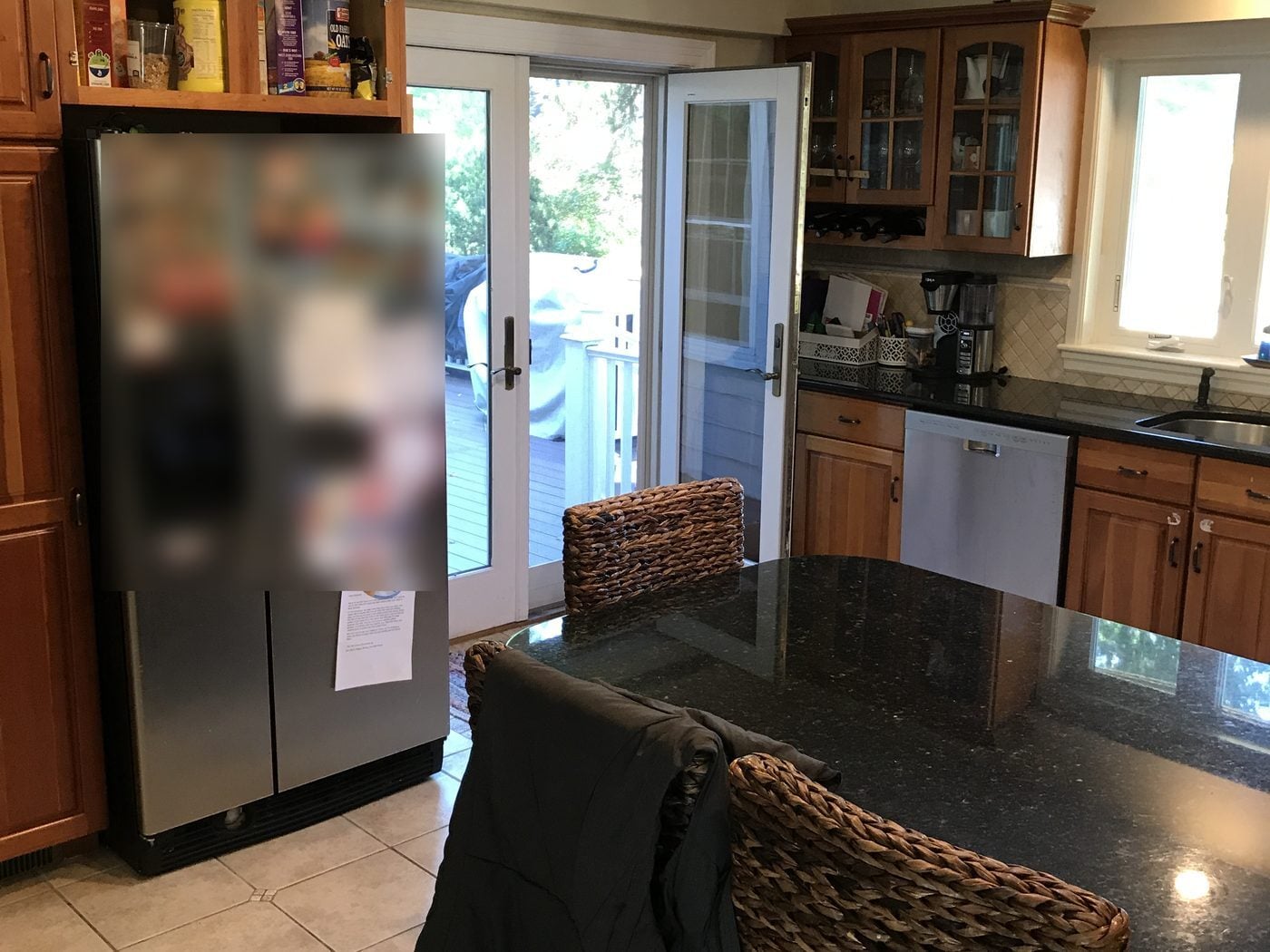 Before: Kitchen to deck: the cramped corner by the fridge and French doors opened into a long island with seating for four and a clear path out to the deck.