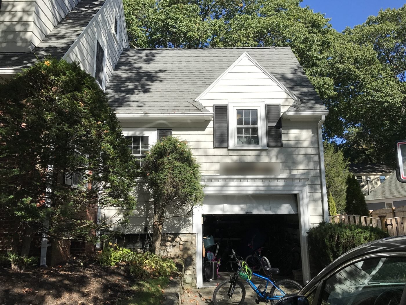 Before: Front: the old garage wing on a stone foundation came down and was rebuilt as a two-story addition with a garage below, a mudroom entry up granite steps, new windows and a new roof.