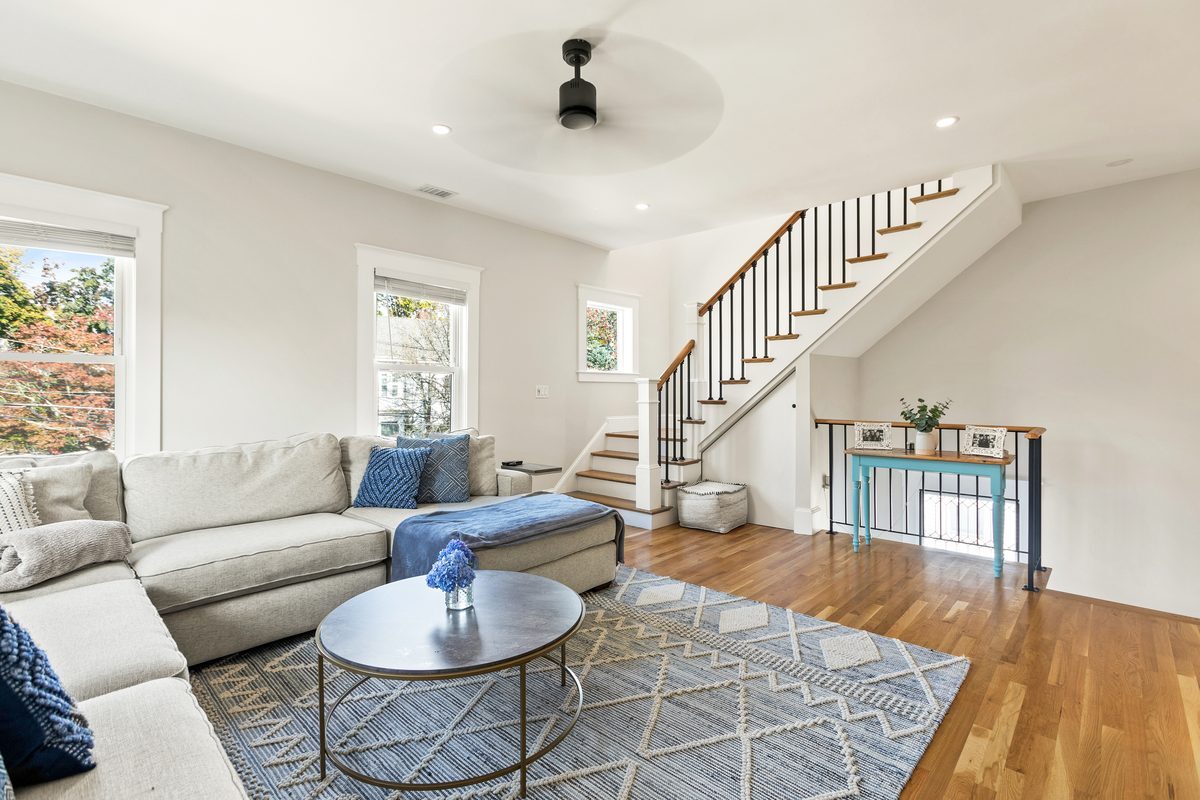 After: Family room: walls and the old chimney came out to open the room and make space for a new oak stair to the third floor.