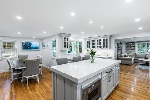 After: Dining room: the wall and narrow doorway into the kitchen came out, so the table now shares one open room with the island.