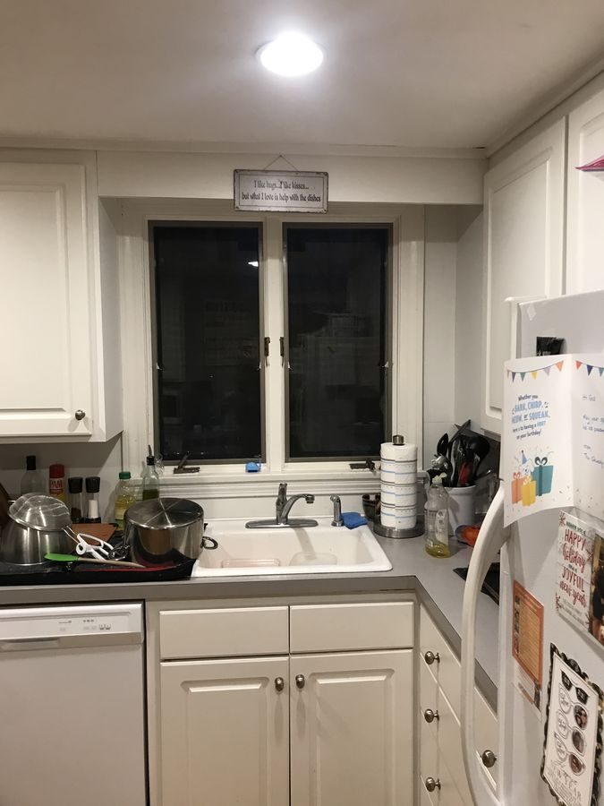 Before: Sink wall: a small double window over laminate became a wider window over quartz, with a herringbone marble backsplash.