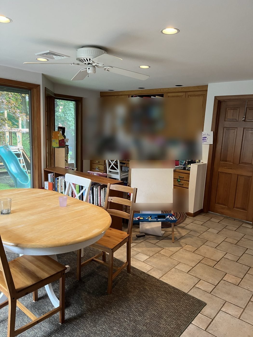 Before: Rear addition: the old desk and craft wall became tall pantry cabinets with a stone counter and floating shelves.